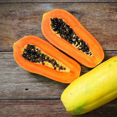 Sliced fresh papaya on wooden background