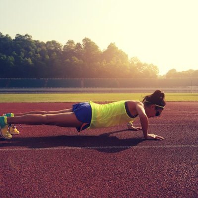 young fitness woman runner push up before run