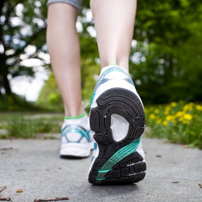 Woman walking cross country and trail in spring forest