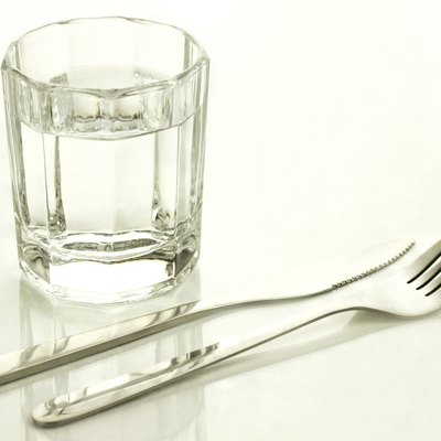 Knife and fork with a glass of water