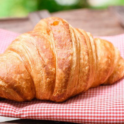 croissant on brown wood table