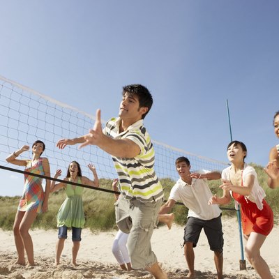 Teenage Friends Playing Volleyball On Beach