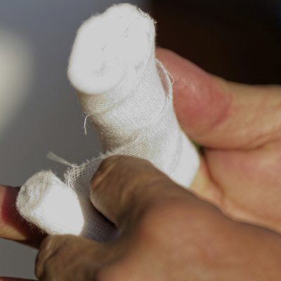 White medicine bandage on human injury hand finger