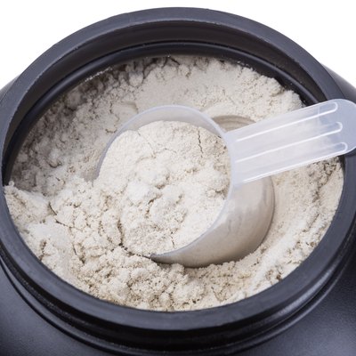 Container of milk whey protein. Close-up.
