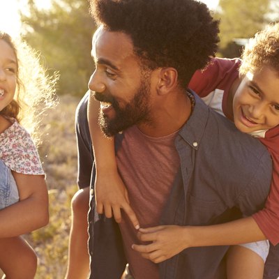 Parents giving their kids piggybacks, waist up, close up