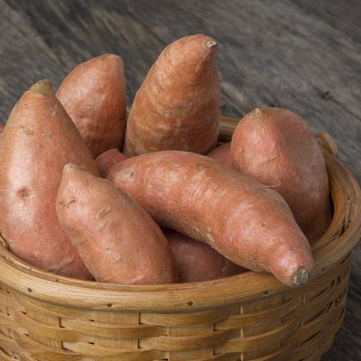 Sweet Potatoes in Basket on Wood Table