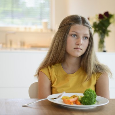 Girl looking bored with healthy meal