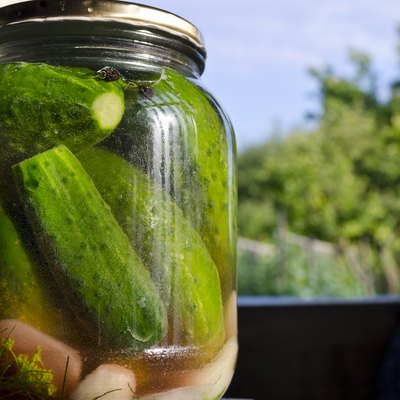 Pickled homemade cucumbers in the glass jar, preserved vegetables