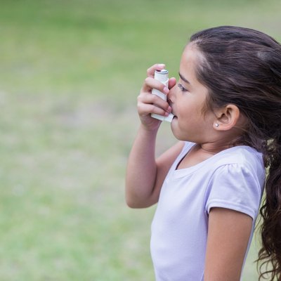 Little girl using his inhaler