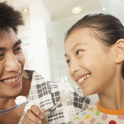 Father and Daughter Brushing Teeth Together