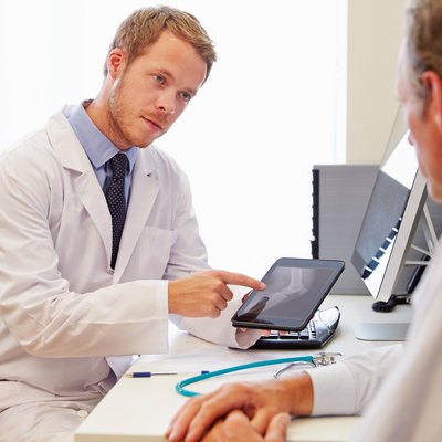 Male Patient Having Consultation With Doctor In Office