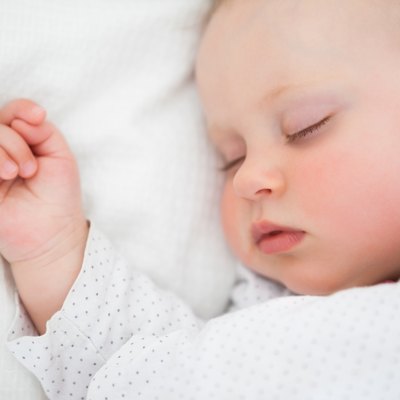 Peaceful baby lying on a bed while sleeping