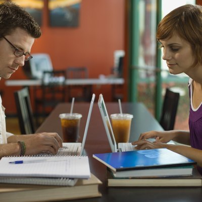 Couple working on laptop computers