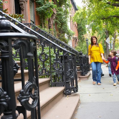 Mother and daughter walking in neighborhood, Manhattan, New York City