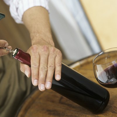 Man opening bottle of wine,close-up of hands