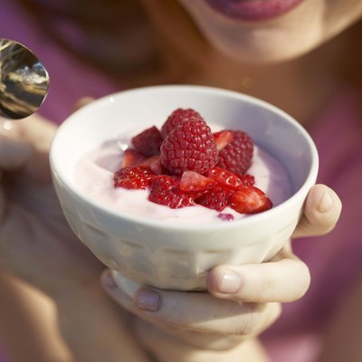 Woman with yogurt and strawberries