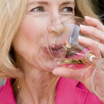 Close-up of mature woman drinking wine