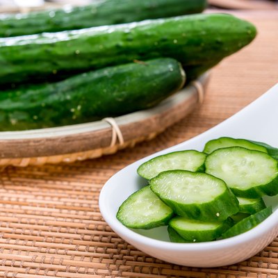 sliced green cucumber in white plate
