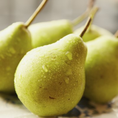 Green pears on a white plate