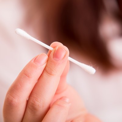 Cotton buds in woman's hand