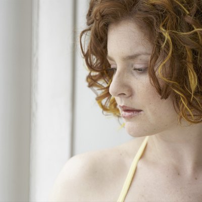 Young woman looking trough window