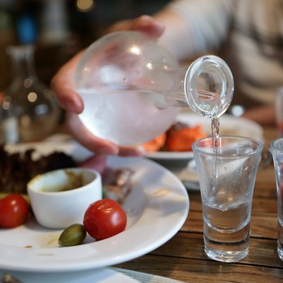 Person pouring vodka from the decanter