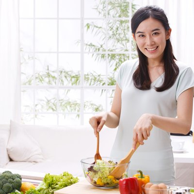 Young woman cooking in kitchen