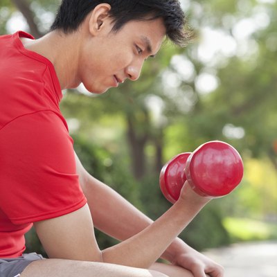 Young Man exercising with Dumbbell