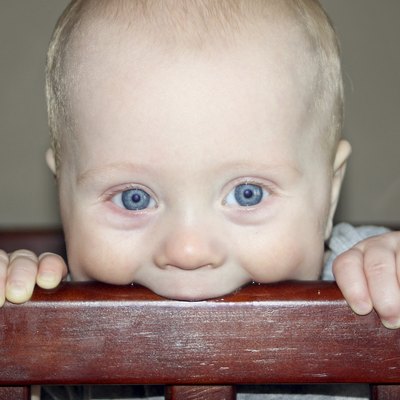 Baby Chewing on Crib