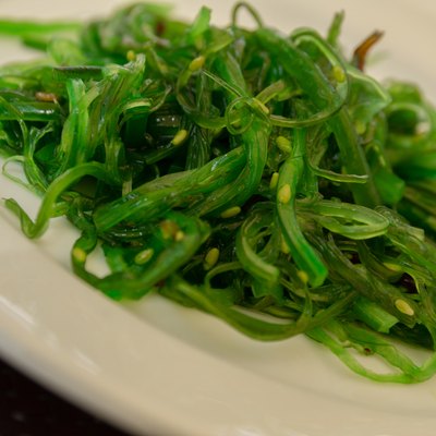 Green Japanese Algae Wakame on White Plate