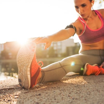 Runner athlete stretching legs