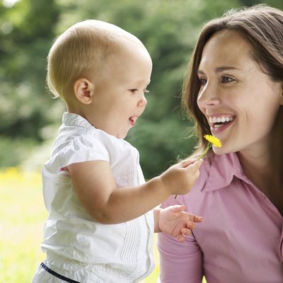 Portrait of a mother and child smiling outdoors