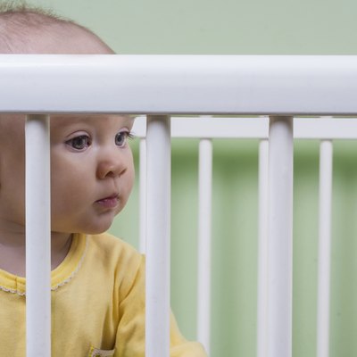 baby sitting in her crib