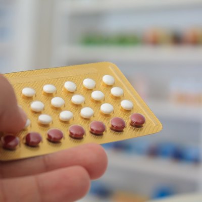 Close up of pharmacist hands holding contraceptive pills