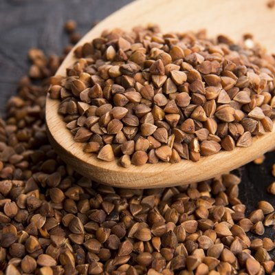 Buckwheat seeds on wooden spoon in closeup