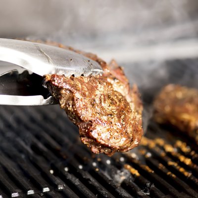 grilling steak on BBQ almost ready