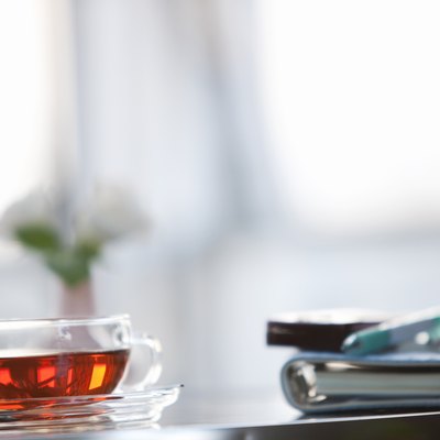Cup of tea on a table with a cellphone and diary