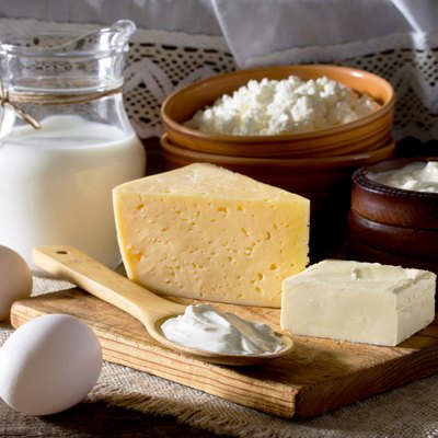 Homemade dairy products and eggs on a wooden table.