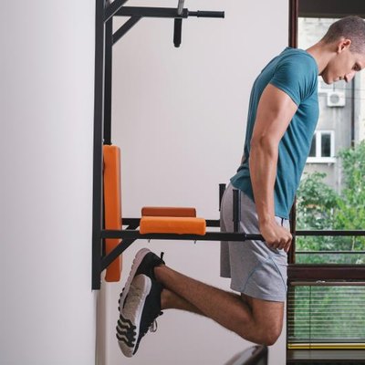 Muscular man working out in front of window