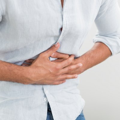 Mid section of man suffering from stomach pain