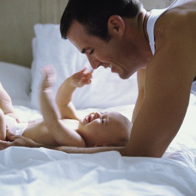 Father playing with baby boy (2-5 months)