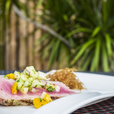 Grilled tuna steak slices with mango-melon salsa