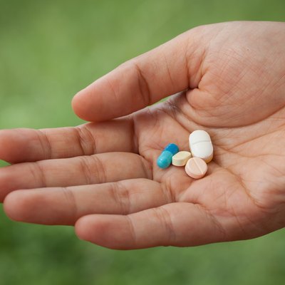 Closeup pills on woman hand