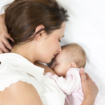 happy mother breast feeding her baby infant