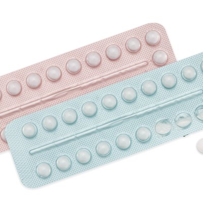 Male and female contraceptive pills, pink, blue on white