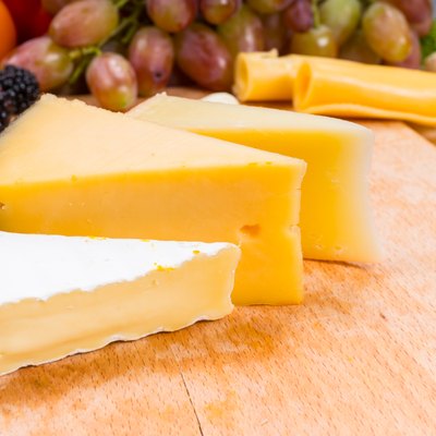 Variety of different cheese wedges on a board
