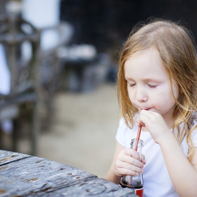 Little girl with a soft drink