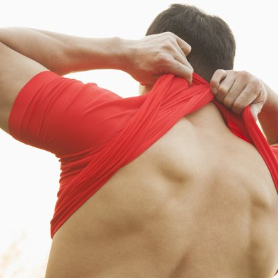 Muscular Man Taking Off His Shirt