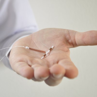 Holding an IUD birth control device in hand