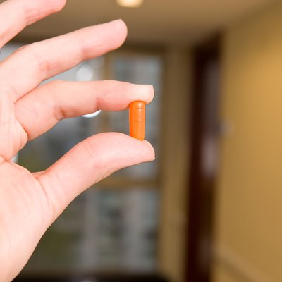 Hand holding a pill